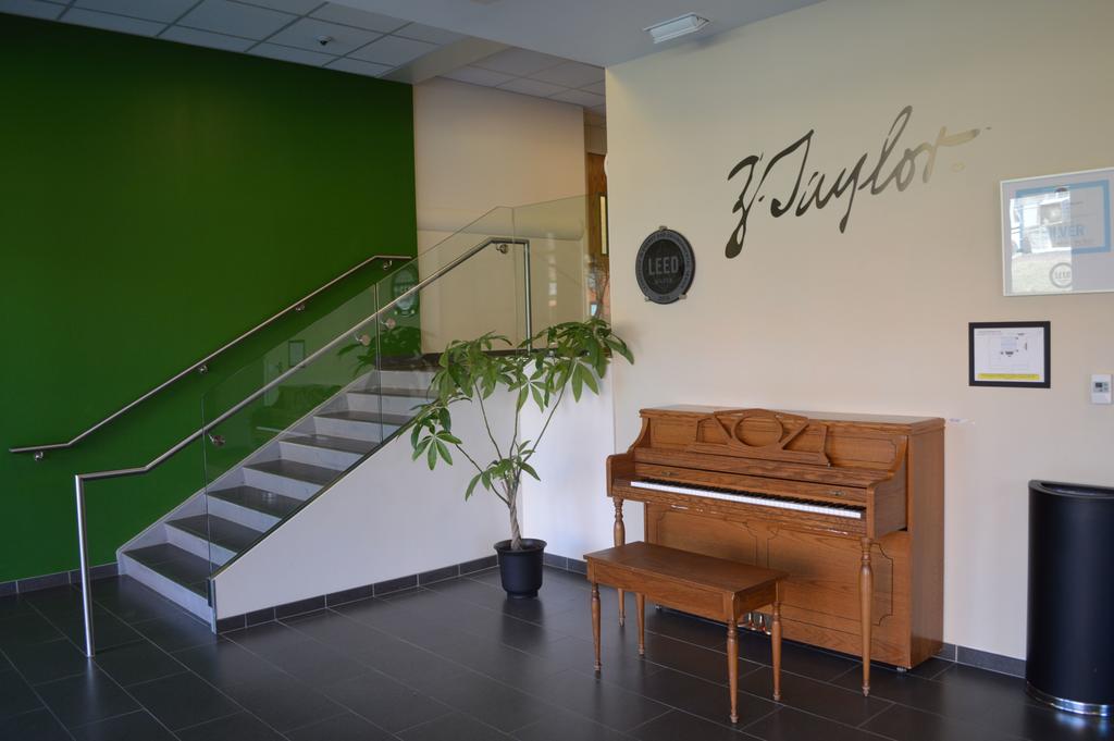 Taylor Hall Lobby with Piano, Plant, and Stairs